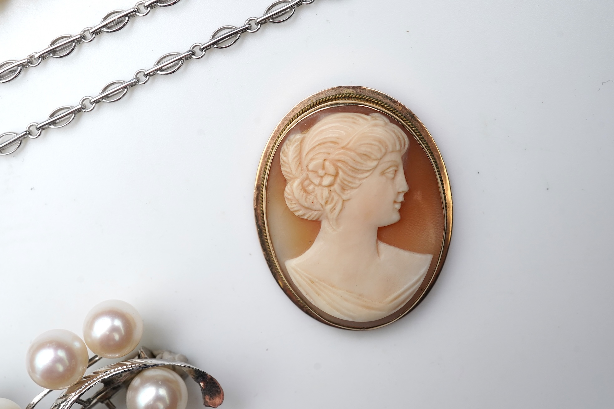 A collection of cultured pearl jewels and a cameo pendant